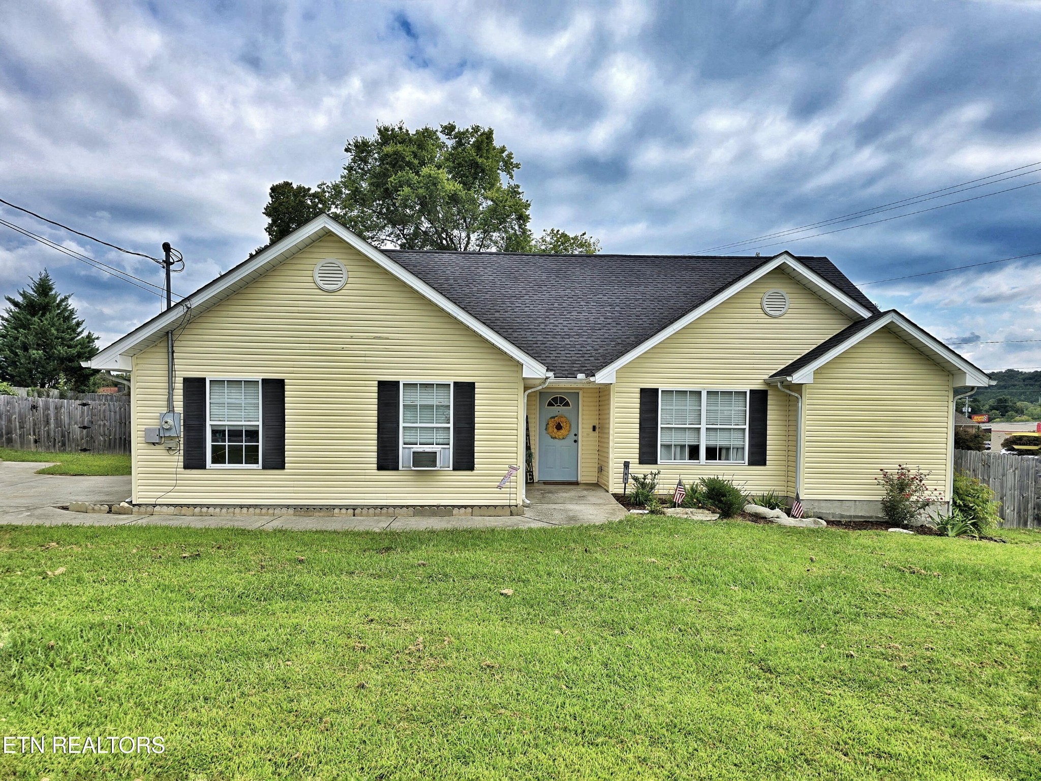 a front view of house with yard and green space
