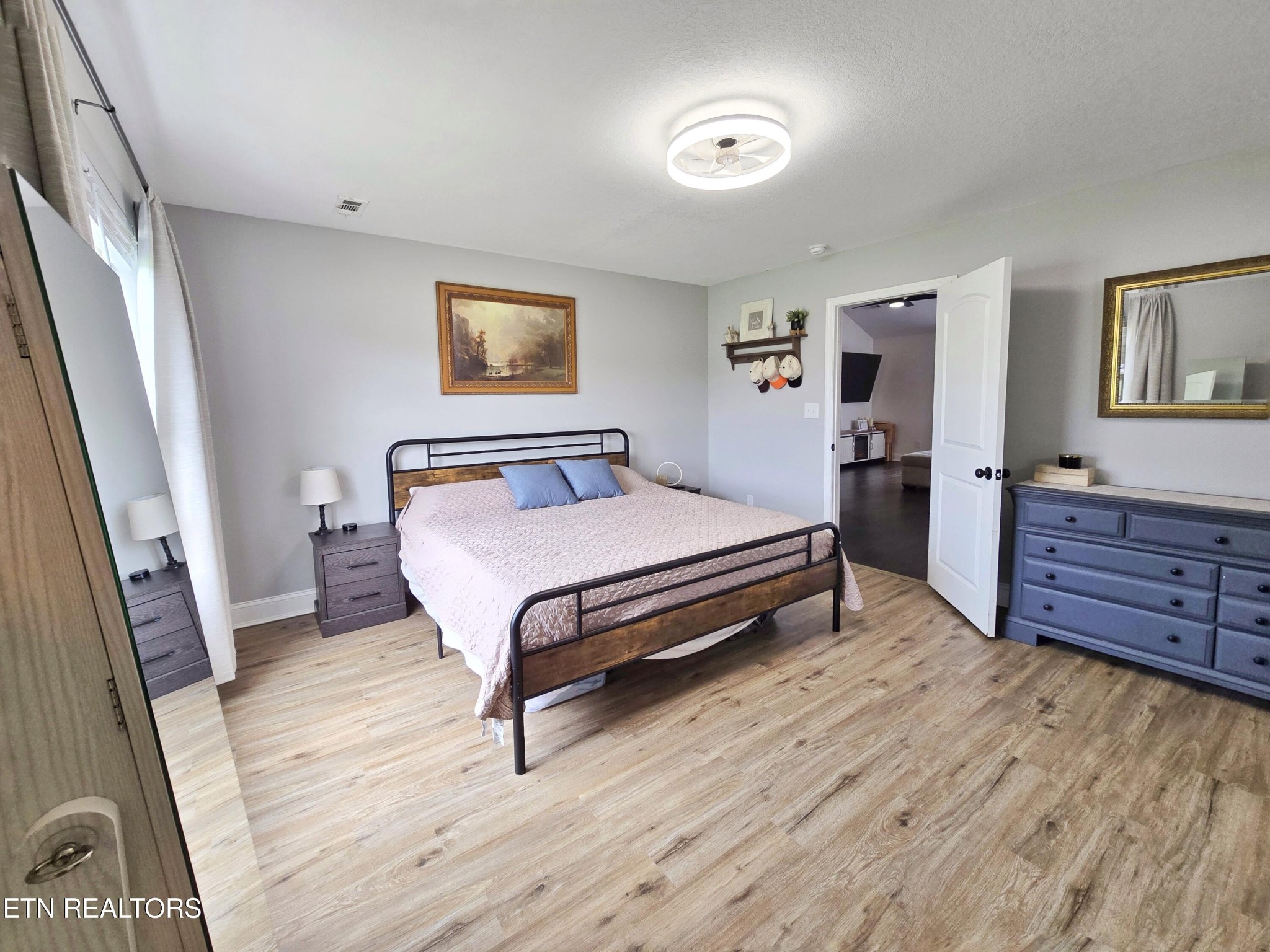 181 Sunset Road Clinton, TN 37716 - Photo 11 of 42 a bedroom with a bed and wooden floor