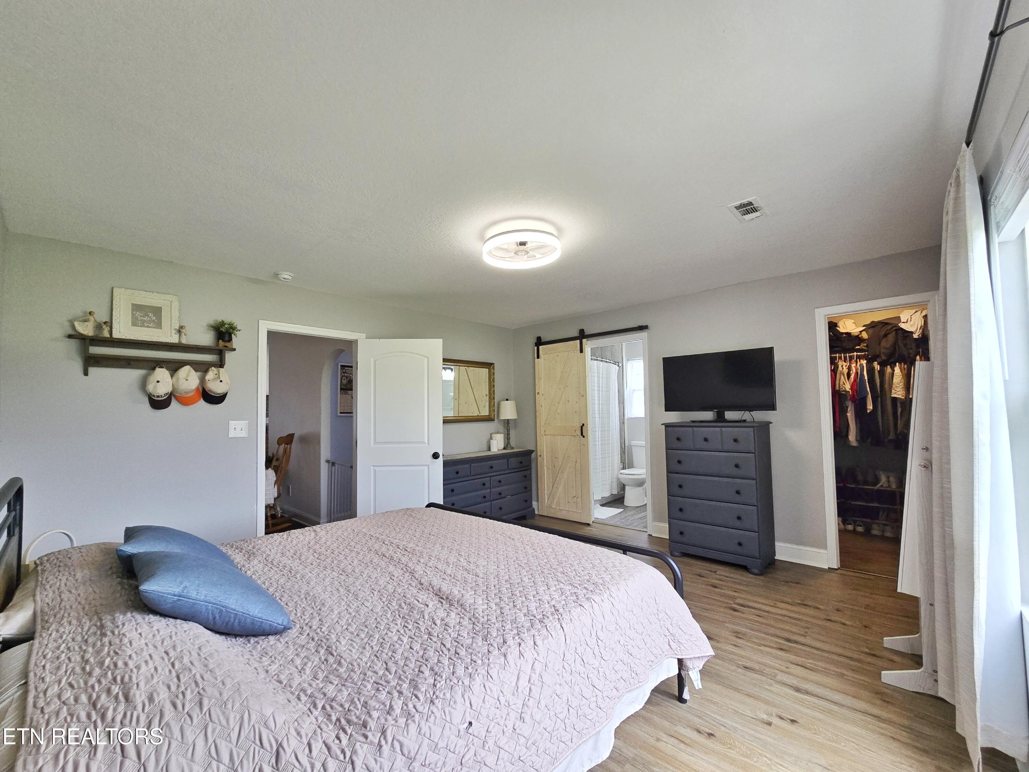 181 Sunset Road Clinton, TN 37716 - Photo 13 of 42 a bedroom with a bed and a flat screen tv