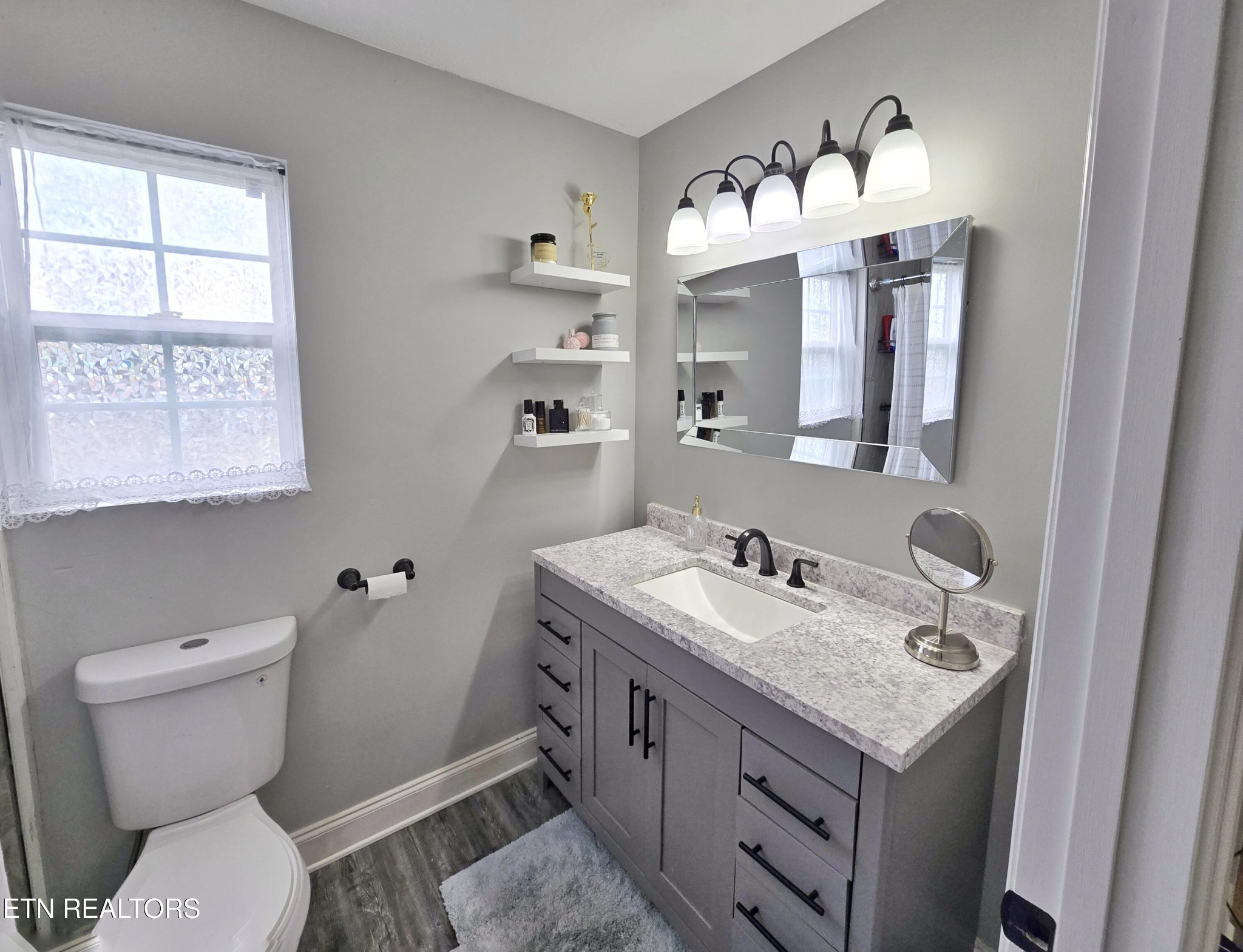 181 Sunset Road Clinton, TN 37716 - Photo 15 of 42 a bathroom with a granite countertop toilet sink and mirror