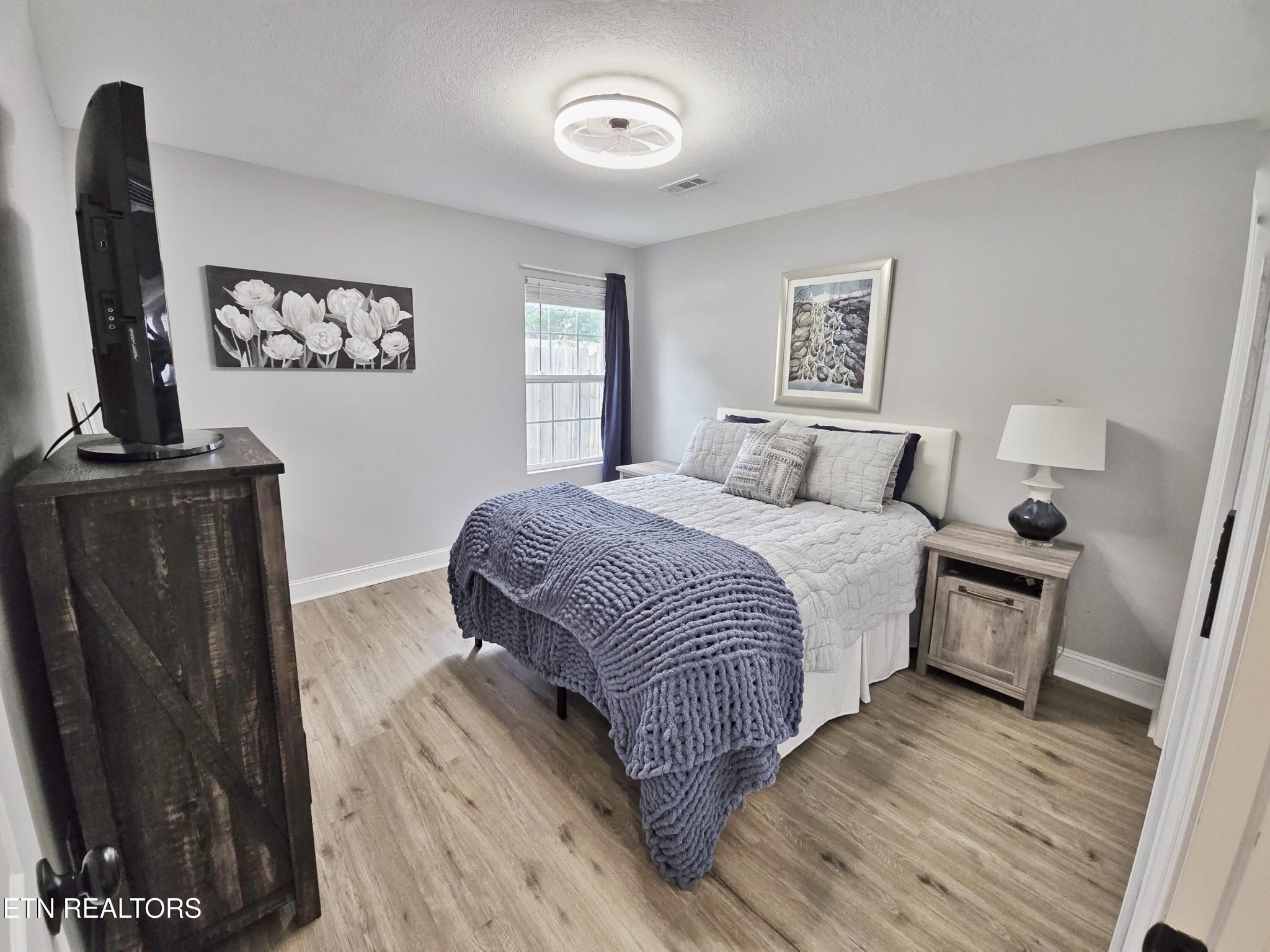 181 Sunset Road Clinton, TN 37716 - Photo 21 of 42 a bedroom with a bed a couch and a window