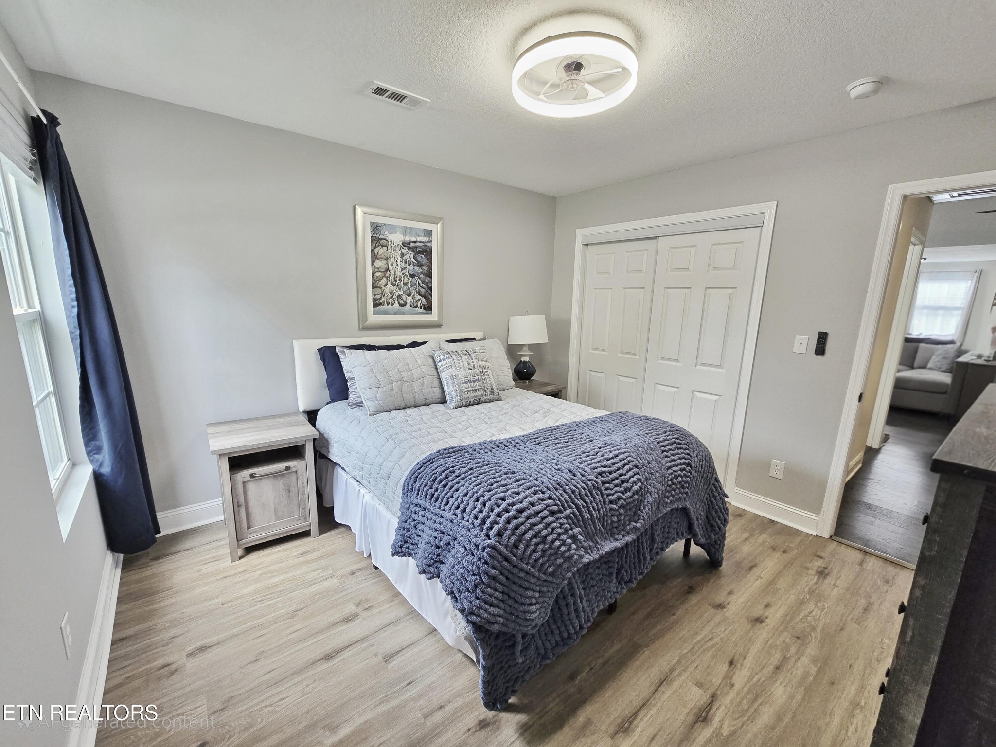 181 Sunset Road Clinton, TN 37716 - Photo 22 of 42 a bedroom with a bed and wooden floor