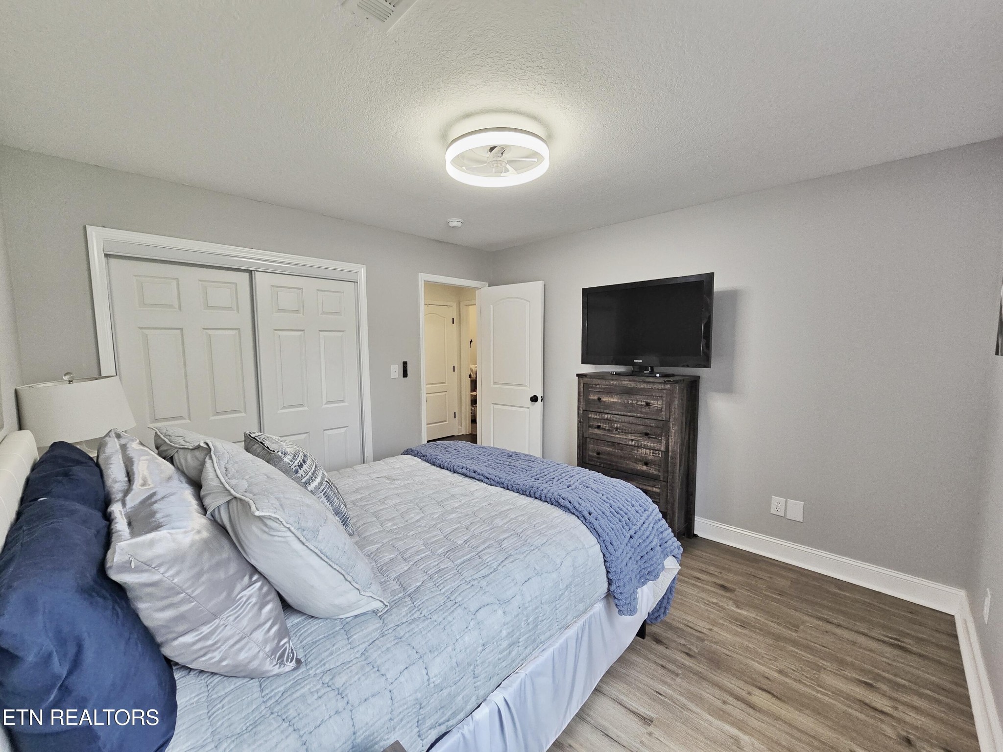 181 Sunset Road Clinton, TN 37716 - Photo 23 of 42 a bedroom with a bed and a flat screen tv