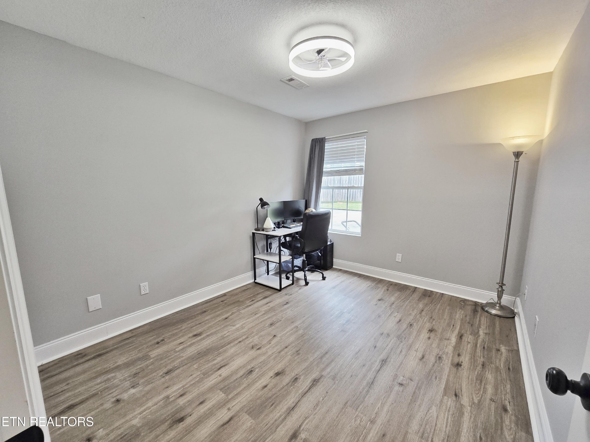 181 Sunset Road Clinton, TN 37716 - Photo 27 of 42 an empty room with piano and wooden floor