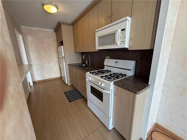 a kitchen with a stove microwave and sink