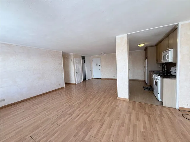 a view of a kitchen with a sink and a refrigerator