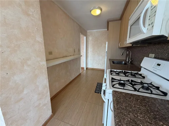 a kitchen with a stove and a refrigerator