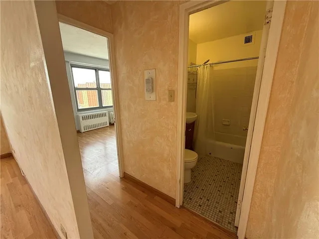 a bathroom with a glass door shower and a sink