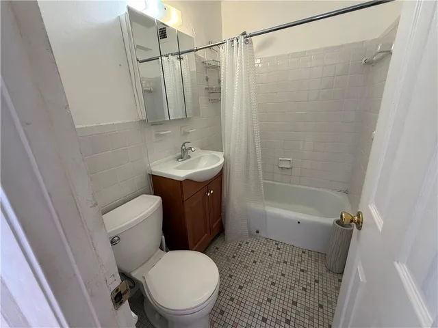 a bathroom with a shower a toilet and sink