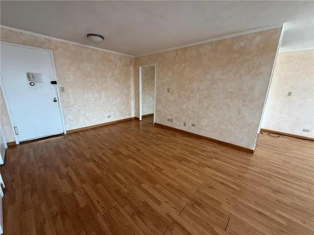 an empty room with wooden floor