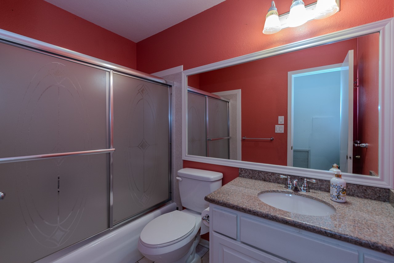 5975 Meadow Way Beaumont, TX 77707 - Photo 17 of 18 a bathroom with a granite countertop sink toilet and shower