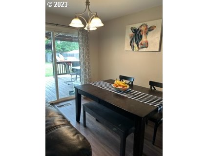429 Toliver Road Molalla, OR 97038 - Photo 9 of 21 a view of a dining room with furniture wooden floor and a chandelier