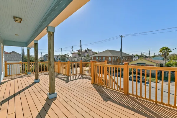 a view of a balcony with wooden floor and iron stairs