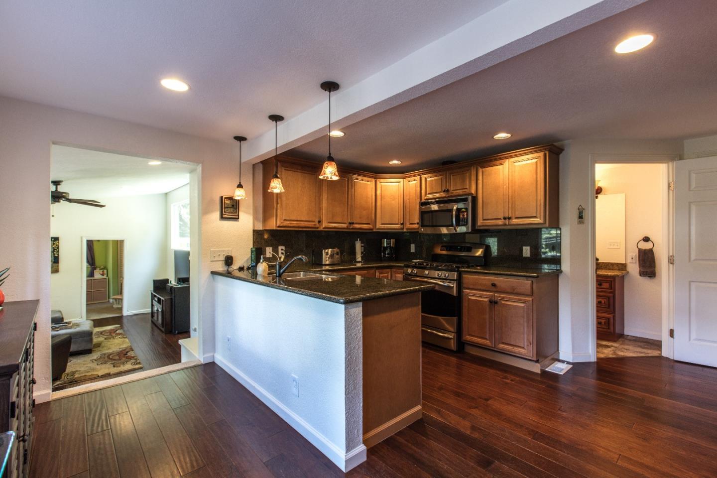 21477 Old Mine Road Los Gatos, CA 95033 - Photo 14 of 27 a kitchen with stainless steel appliances granite countertop wooden floors and view living room
