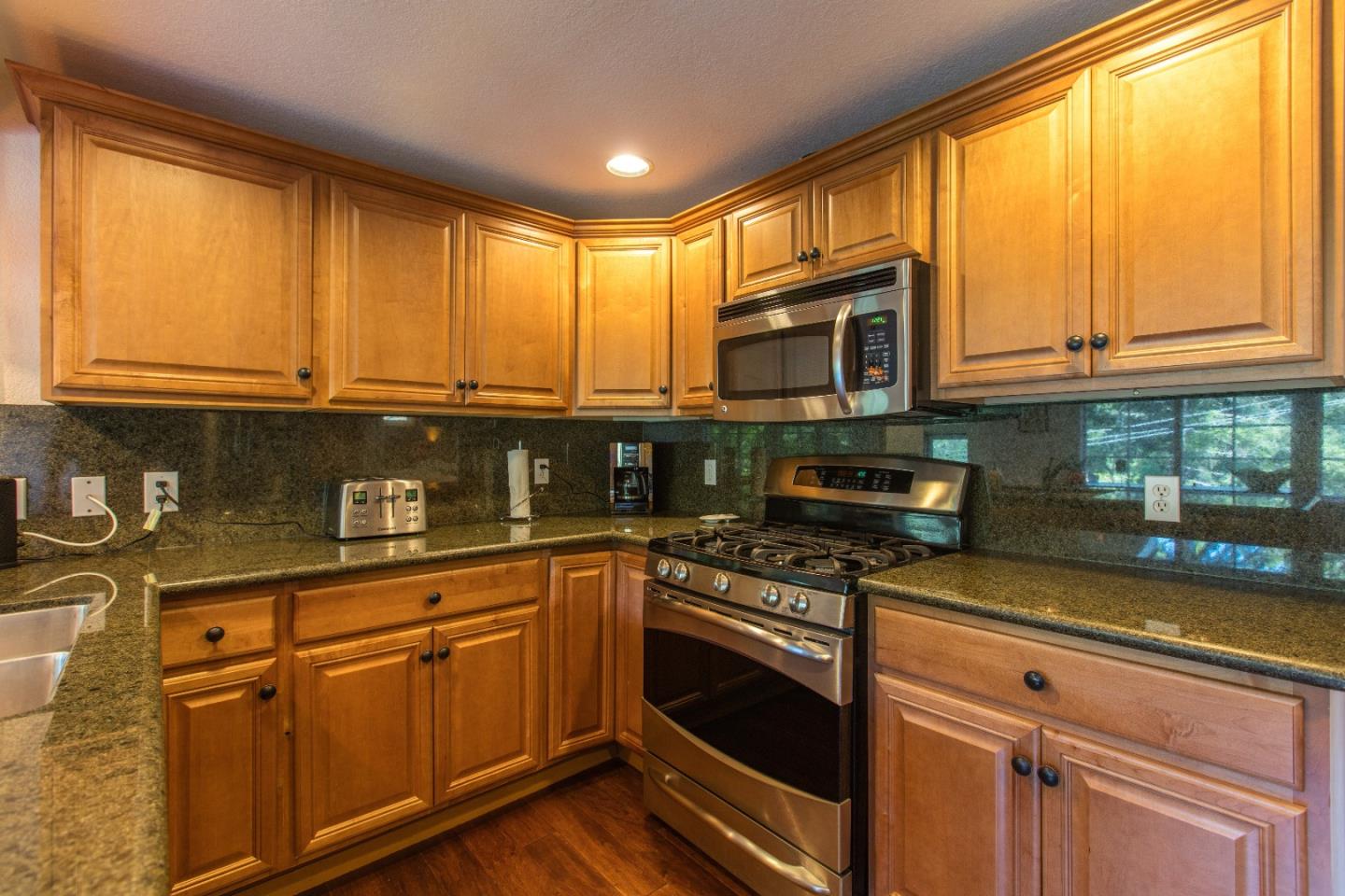21477 Old Mine Road Los Gatos, CA 95033 - Photo 16 of 27 a kitchen with stainless steel appliances granite countertop a stove a sink and a microwave