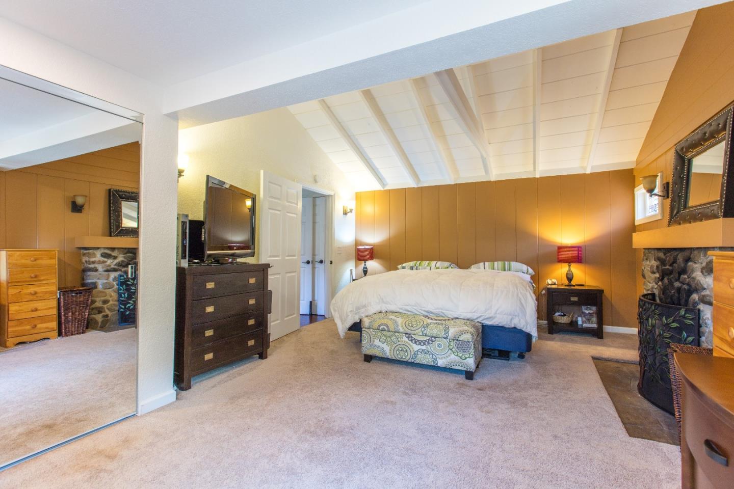 21477 Old Mine Road Los Gatos, CA 95033 - Photo 20 of 27 a spacious bedroom with a bed and a couch