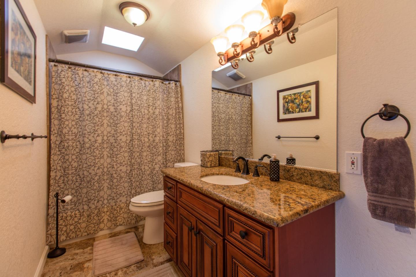 21477 Old Mine Road Los Gatos, CA 95033 - Photo 22 of 27 a bathroom with a granite countertop sink and a mirror