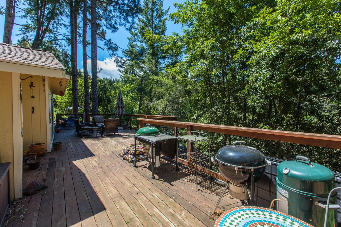 21477 Old Mine Road Los Gatos, CA 95033 - Photo 24 of 27 a balcony with wooden floor table and chairs
