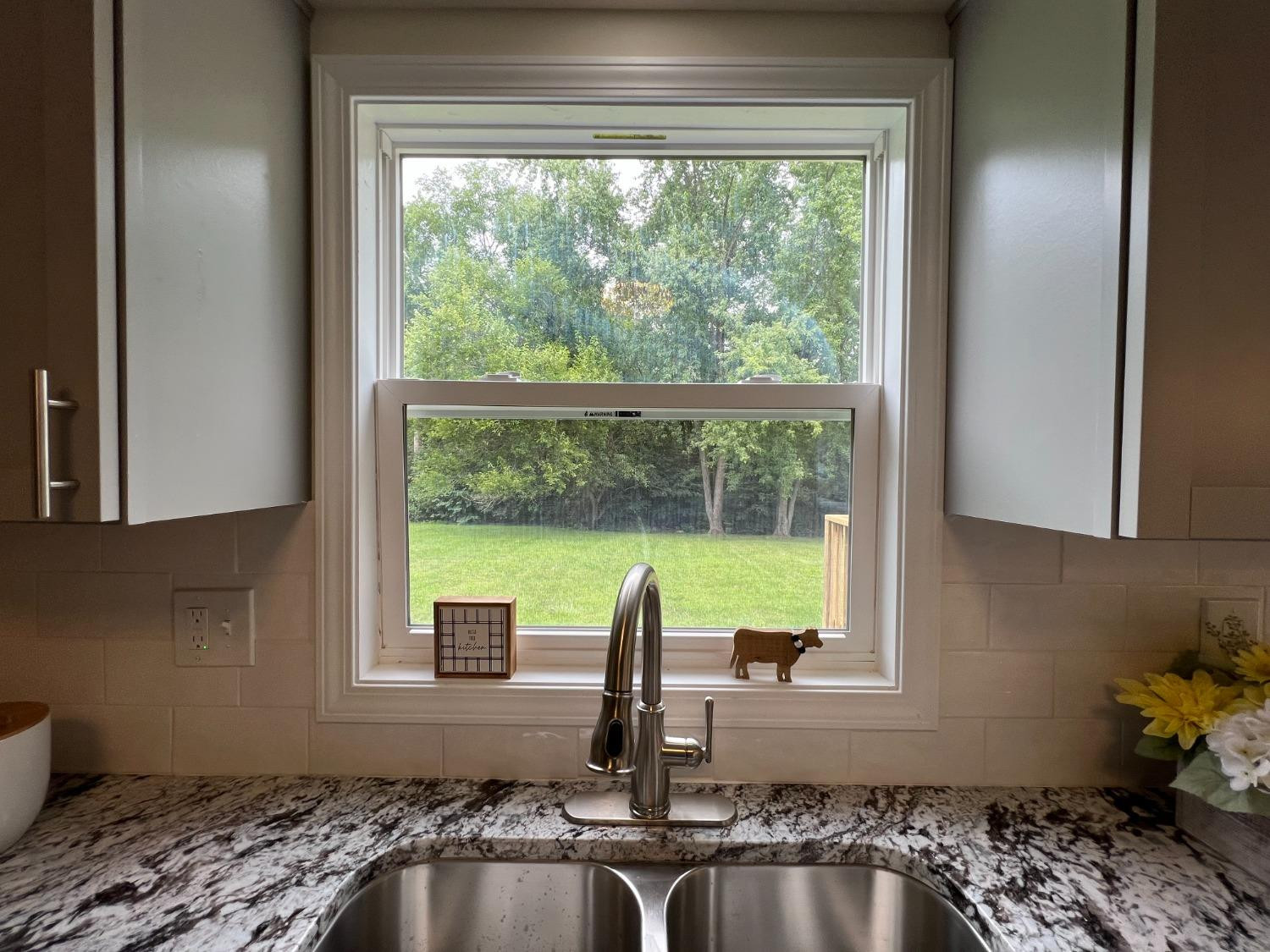 237 Krouser Drive Valparaiso, IN 46385 - Photo 11 of 31 a kitchen with a window sink and cabinets