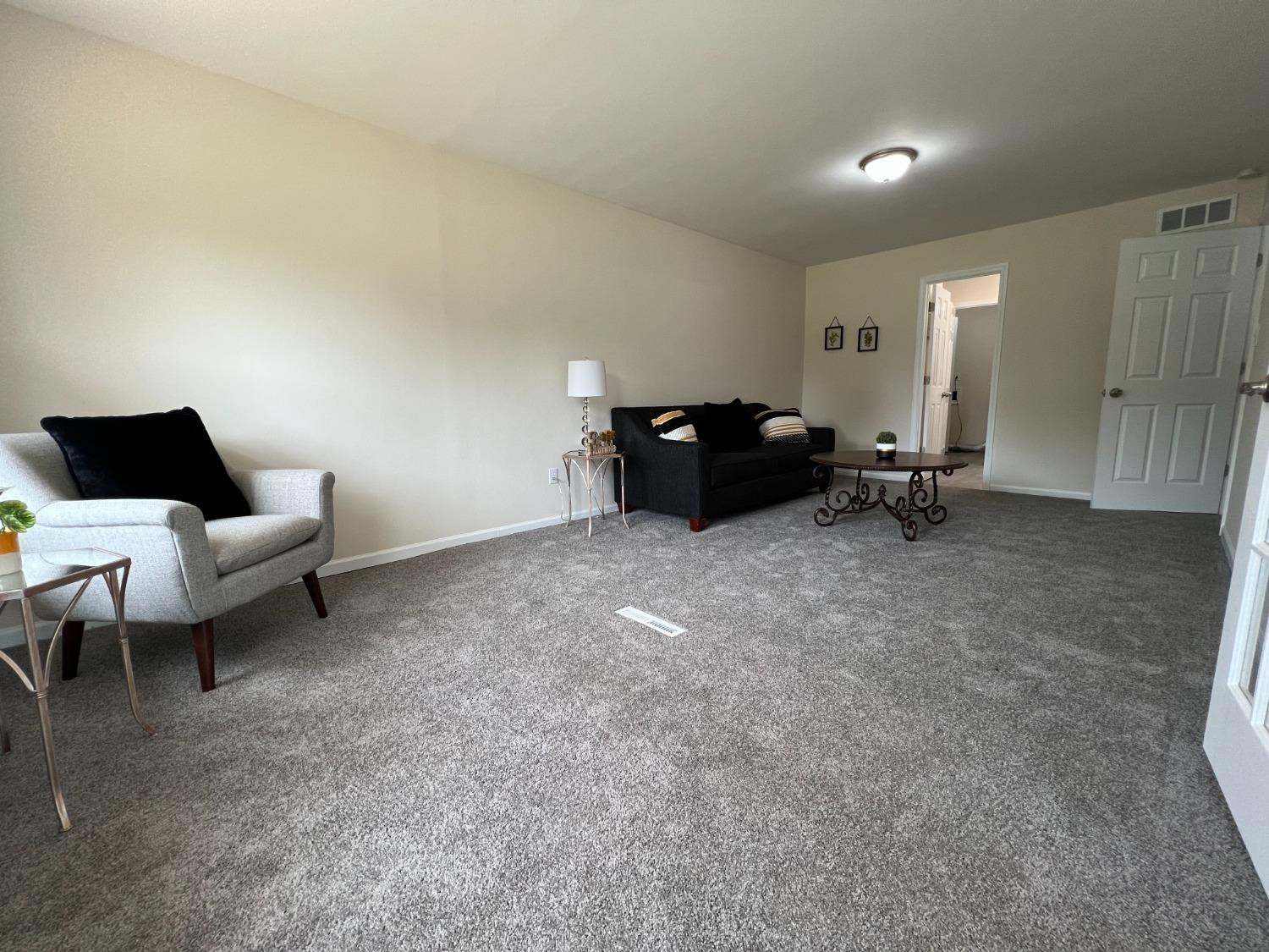 237 Krouser Drive Valparaiso, IN 46385 - Photo 14 of 31 a living room with furniture and a lamp