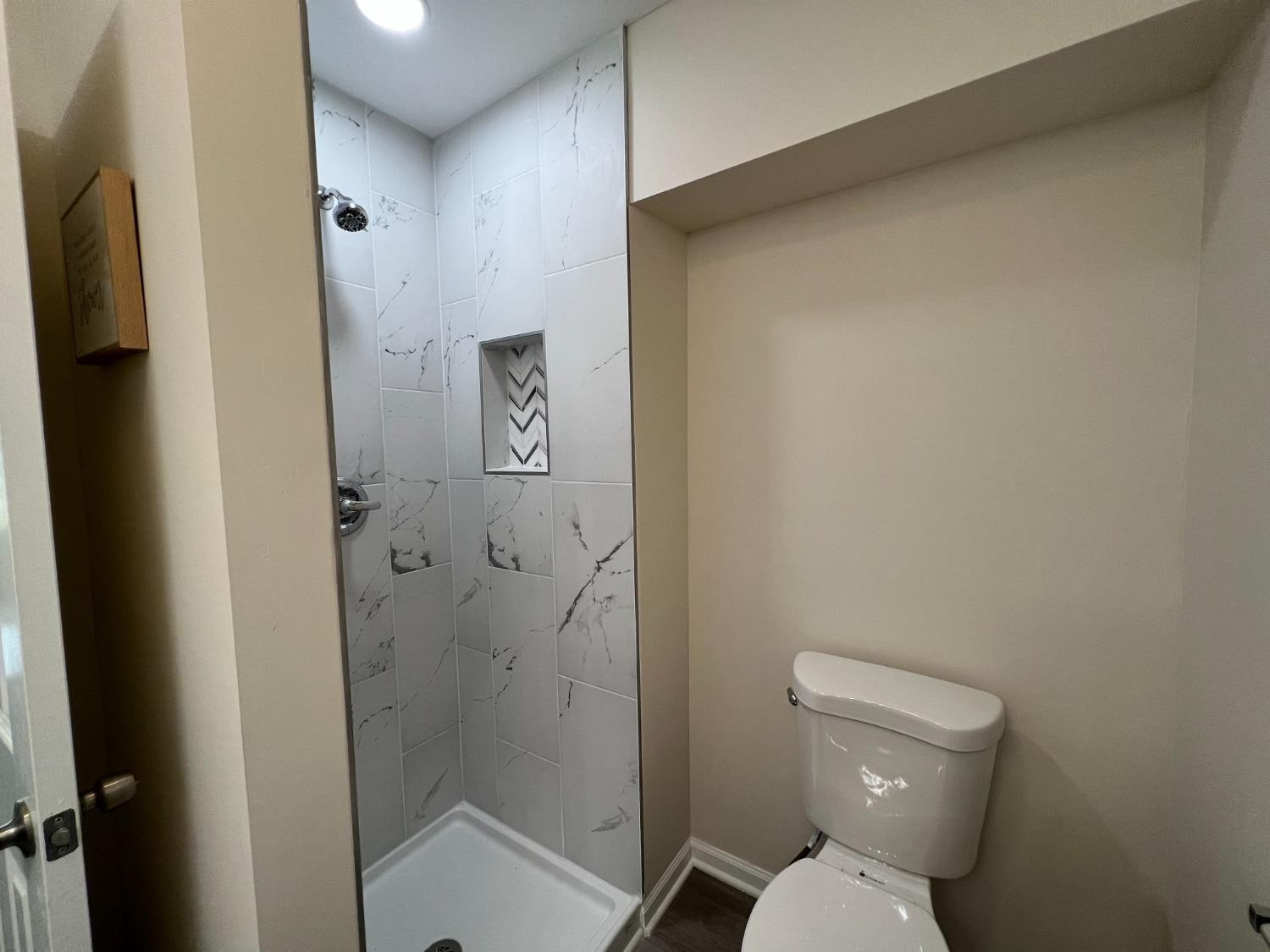 237 Krouser Drive Valparaiso, IN 46385 - Photo 16 of 31 a bathroom with a toilet and a shower