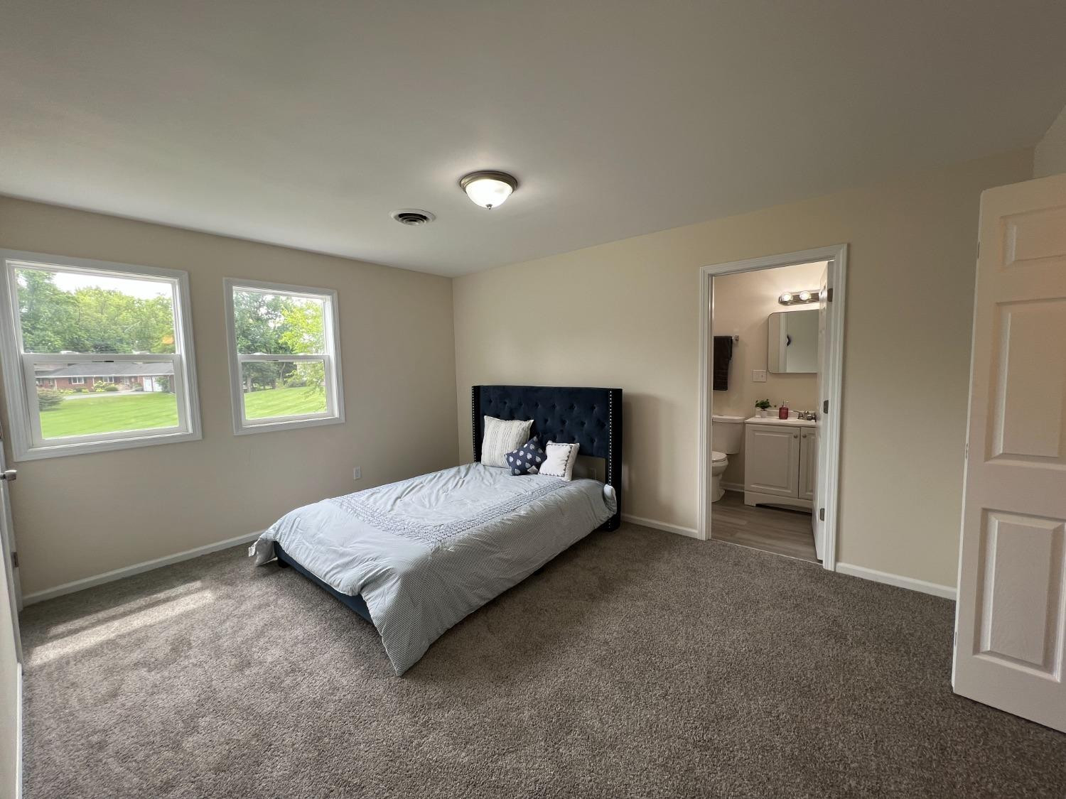 237 Krouser Drive Valparaiso, IN 46385 - Photo 17 of 31 a spacious bedroom with a bed and a window