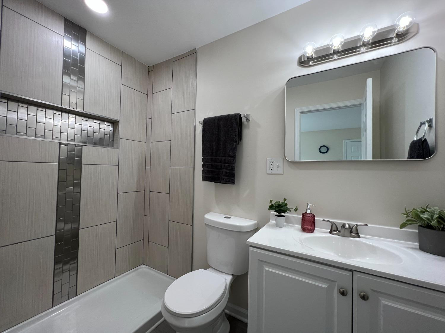 237 Krouser Drive Valparaiso, IN 46385 - Photo 19 of 31 a bathroom with a toilet sink and mirror