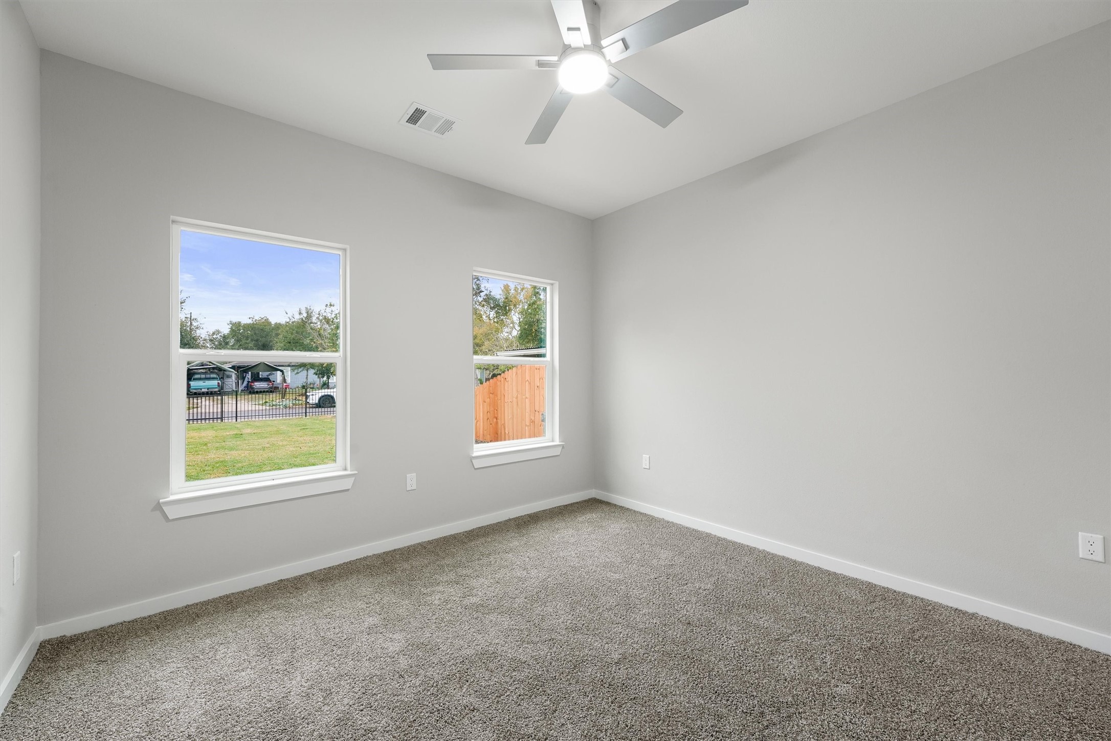 1208 Richard Avenue Pasadena, TX 77506 - Photo 16 of 27 an empty room with windows and chandelier fan