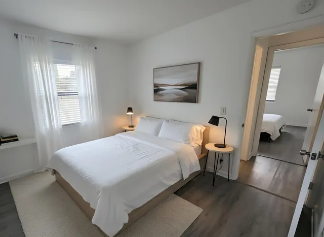 a bedroom with a bed and a large mirror