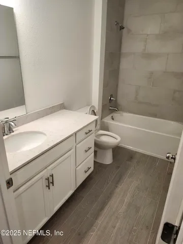 a spacious bathroom with a toilet a sink and bathtub