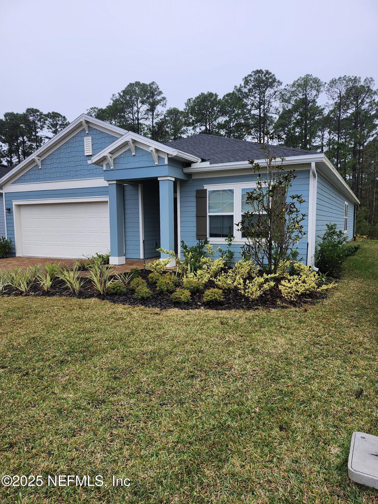 607 Lake Sinclair Street St. Augustine, FL 32084 - Photo 2 of 19 a front view of house with yard and trees