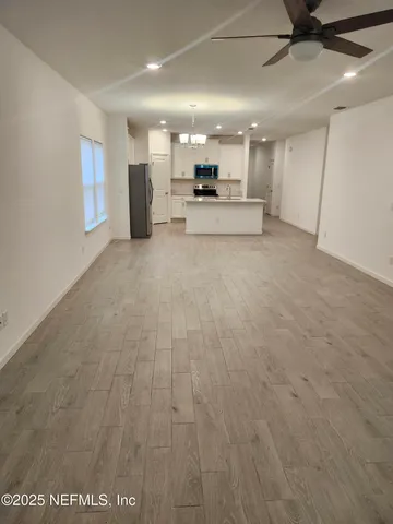 a view of a kitchen with a sink and a refrigerator
