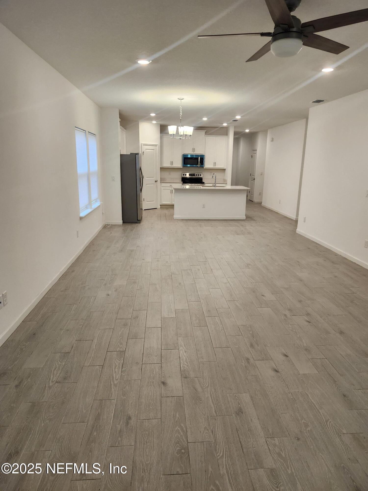 607 Lake Sinclair Street St. Augustine, FL 32084 - Photo 8 of 19 a view of a kitchen with a sink and a refrigerator