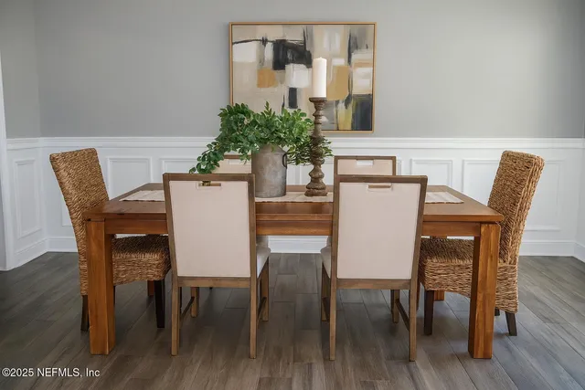 a view of a dining room with furniture and wooden floor