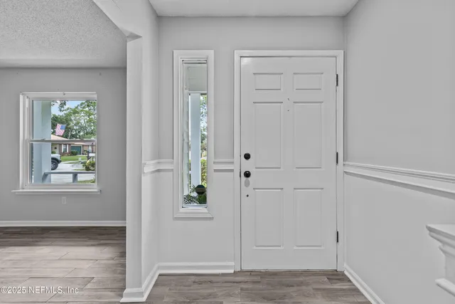 a dining room with furniture and wooden floor