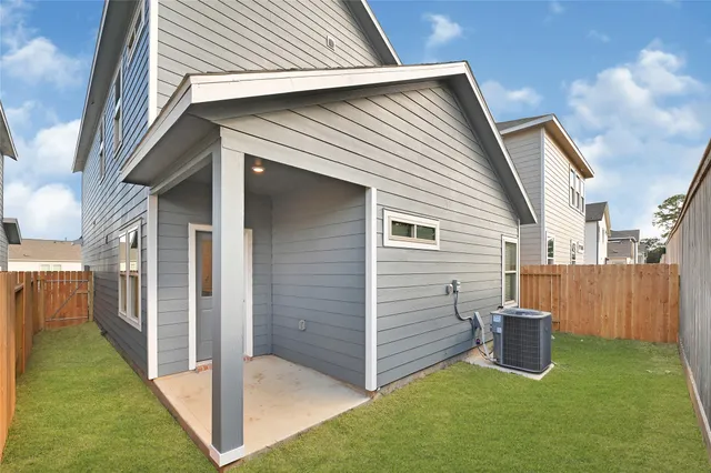 a view of a small house with backyard