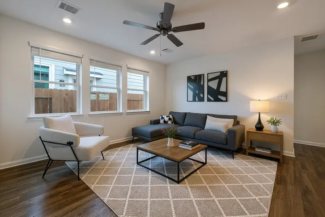a living room with furniture a table and a window