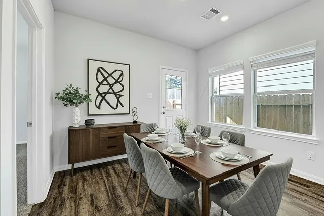 a view of a dining room with furniture large window and wooden floor