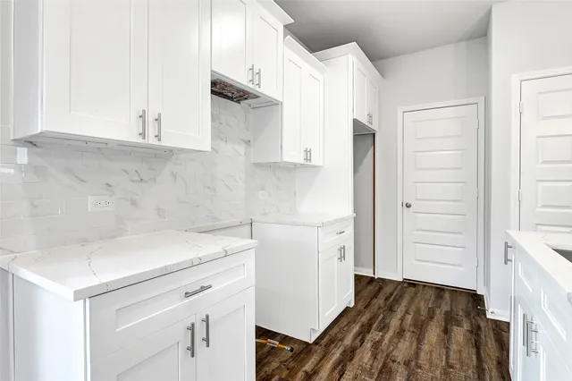 a view of a storage and utility room with closet dryer