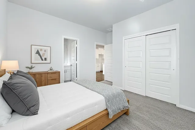 a bedroom with a bed and cabinet