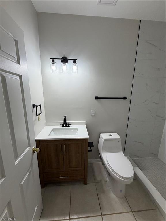 4281 22nd Avenue Southwest, Unit 80 Naples, FL 34116 - Photo 12 of 20 a bathroom with a toilet a sink and mirror
