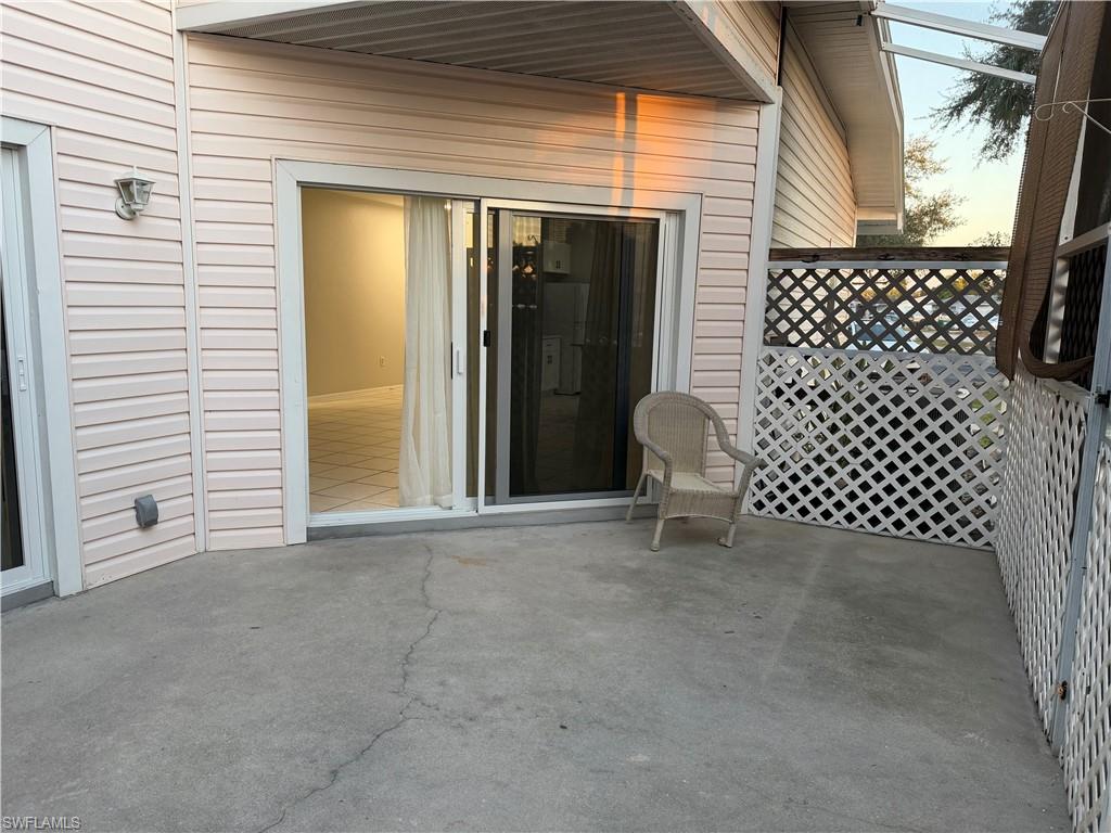 4281 22nd Avenue Southwest, Unit 80 Naples, FL 34116 - Photo 18 of 20 a view of a door with a chair