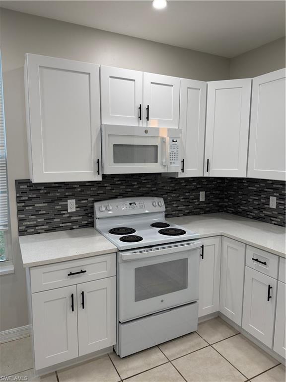 4281 22nd Avenue Southwest, Unit 80 Naples, FL 34116 - Photo 5 of 20 a kitchen with white cabinets and white appliances