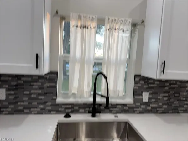 a close view of a sink and a microwave in a kitchen