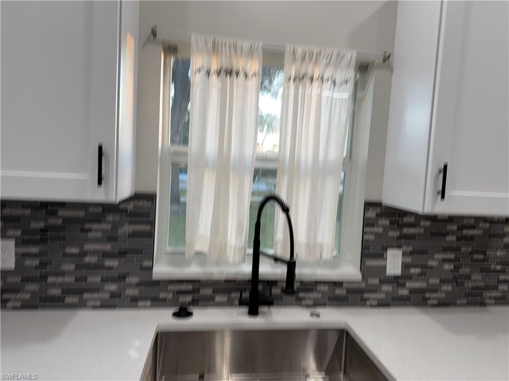 4281 22nd Avenue Southwest, Unit 80 Naples, FL 34116 - Photo 6 of 20 a close view of a sink and a microwave in a kitchen