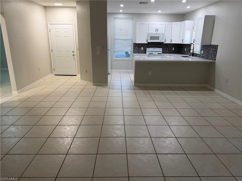4281 22nd Avenue Southwest, Unit 80 Naples, FL 34116 - Photo 9 of 20 a view of a kitchen with cabinets