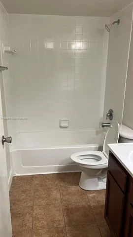 a bathroom with a toilet a sink and a shower