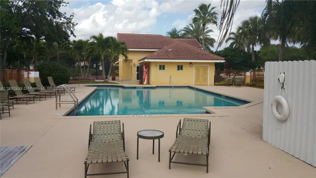 swimming pool view with a seating space