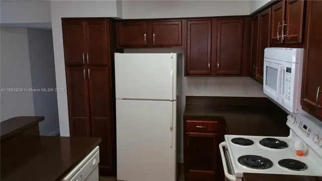 a kitchen with a refrigerator and a stove