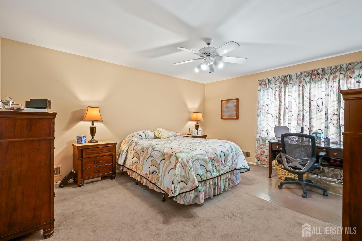 41 Rodak Circle Edison, NJ 08817 - Photo 21 of 28 a bedroom with a bed and a chandelier